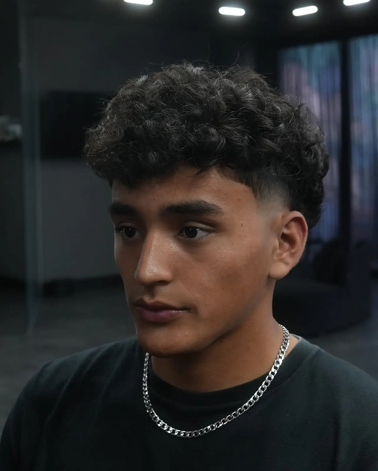 Curly top kept long with a fade at the sides at ONYX barbershop in Hallandale Beach, FL