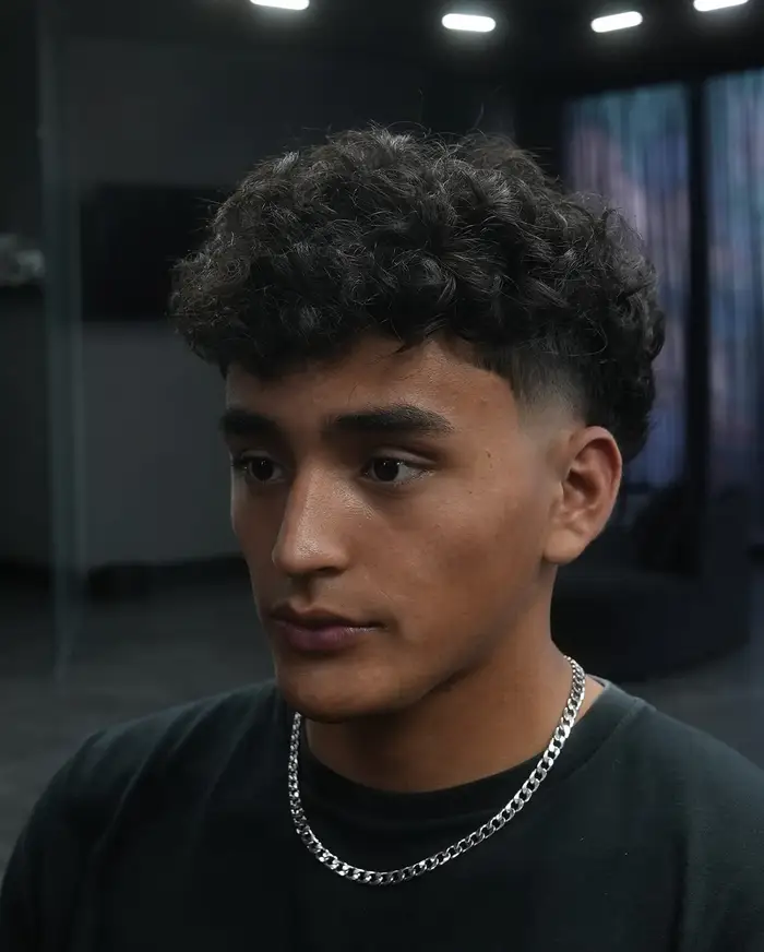 Curly top kept long with a fade at the sides at ONYX barbershop in Hallandale Beach, FL