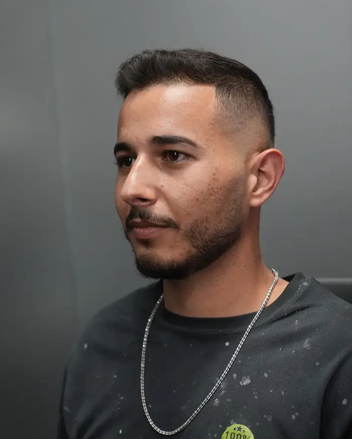 High skin fade with the top brushed forward and a shaped beard line at ONYX barbershop in Hallandale Beach, FL