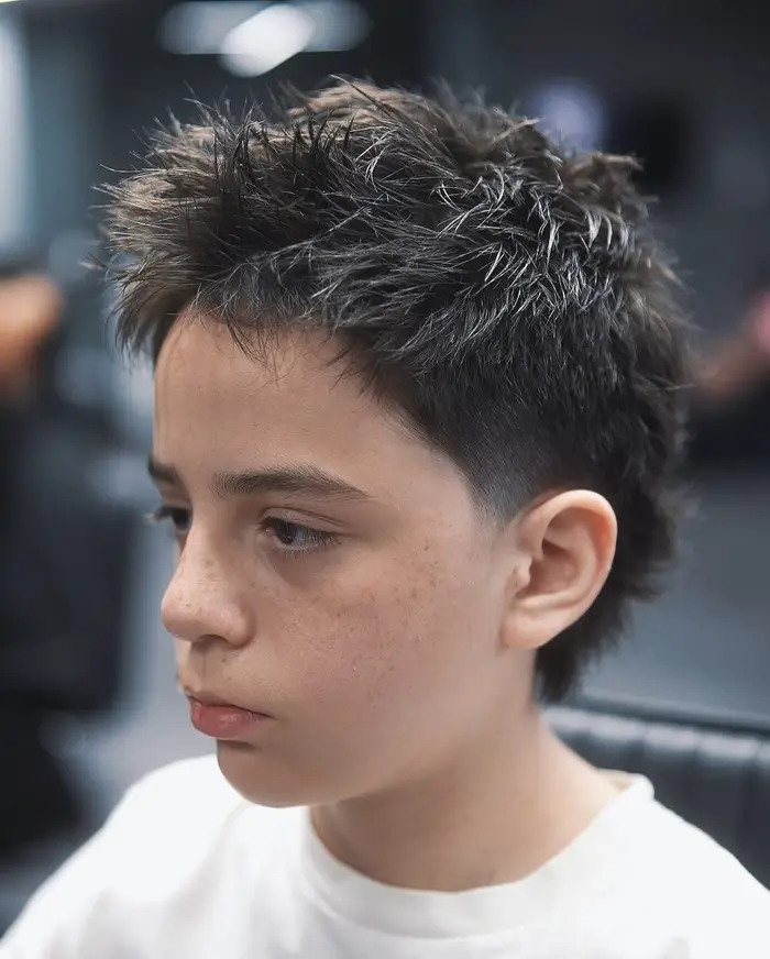 Textured crop with a taper on thick hair, cut for a young client at ONYX barbershop in Hallandale Beach, FL