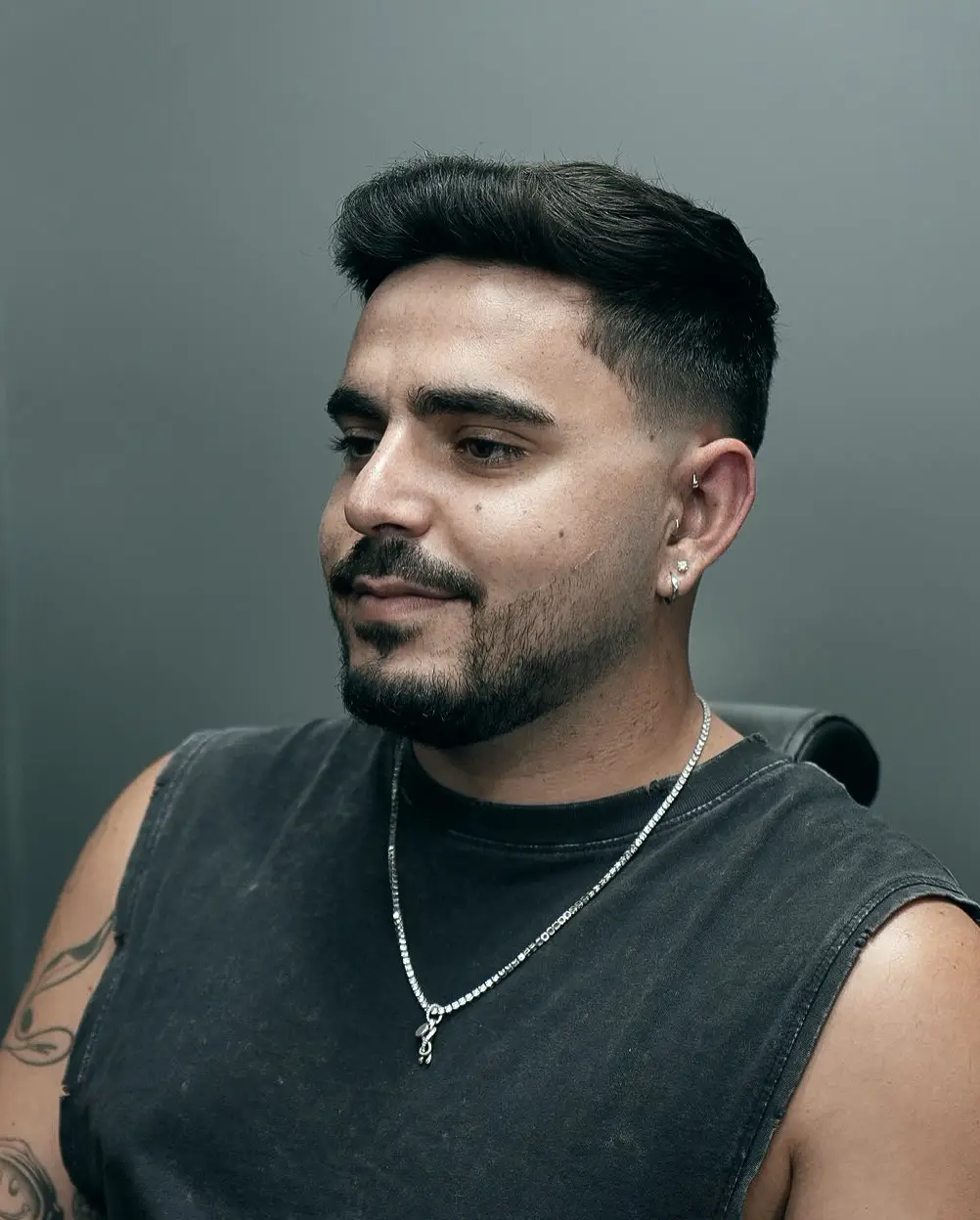 Mid fade haircut with brushed-back top at ONYX barbershop in Hallandale Beach, FL