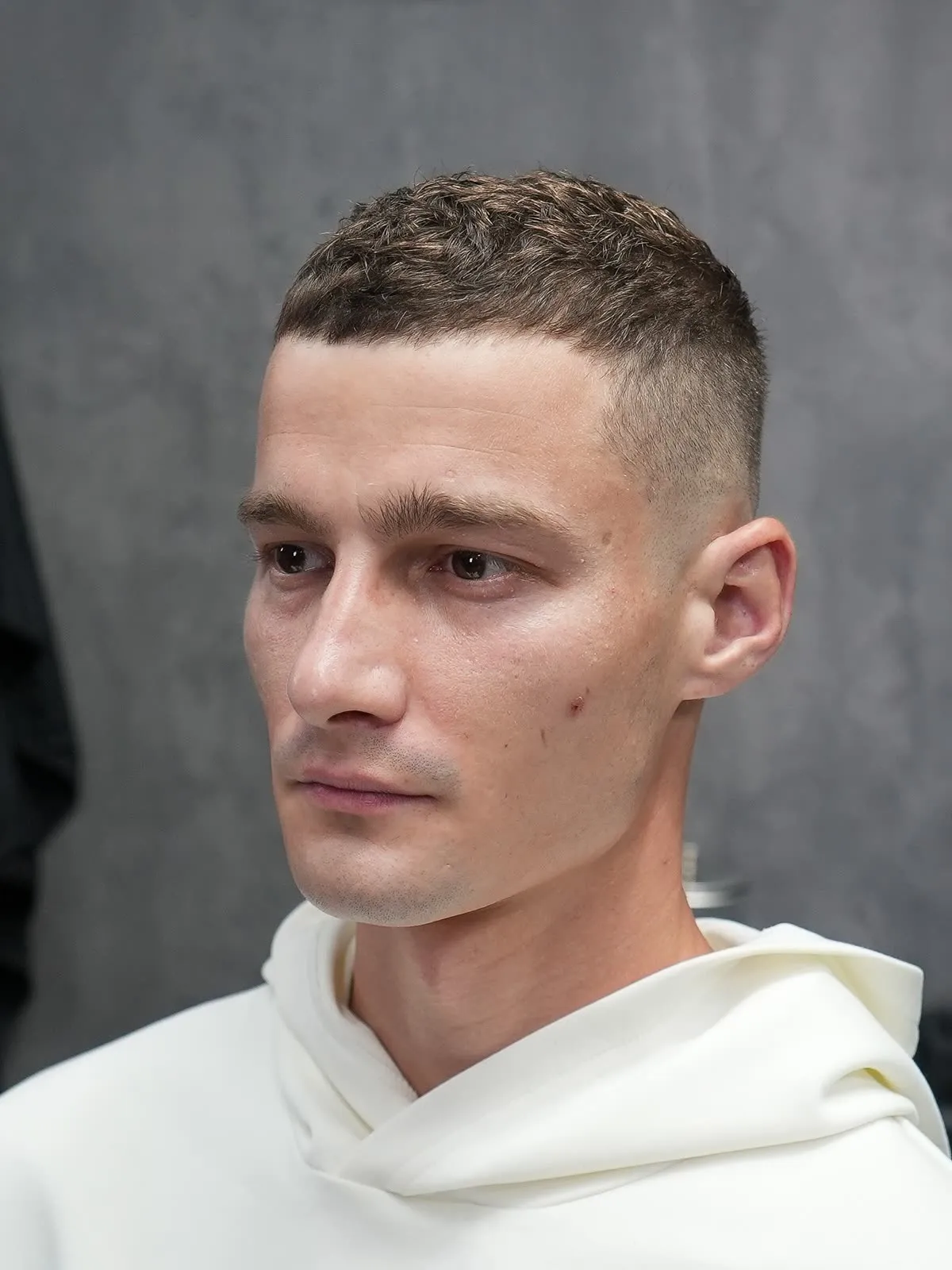 Short haircut with soft transitions and a clean fade lowering hairline contrast at ONYX Barbershop in Hallandale Beach, FL