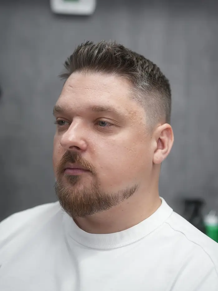 Taper fade with a spiky top and a shaped goatee showing grey at ONYX barbershop in Hallandale Beach, FL