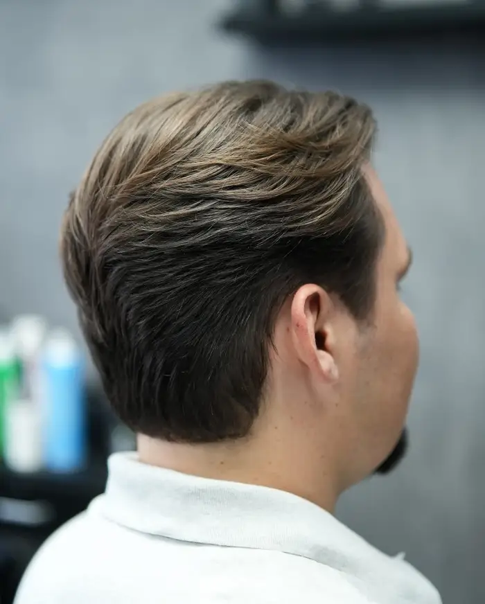 Back view of a layered taper finished into the nape at ONYX barbershop in Hallandale Beach, FL